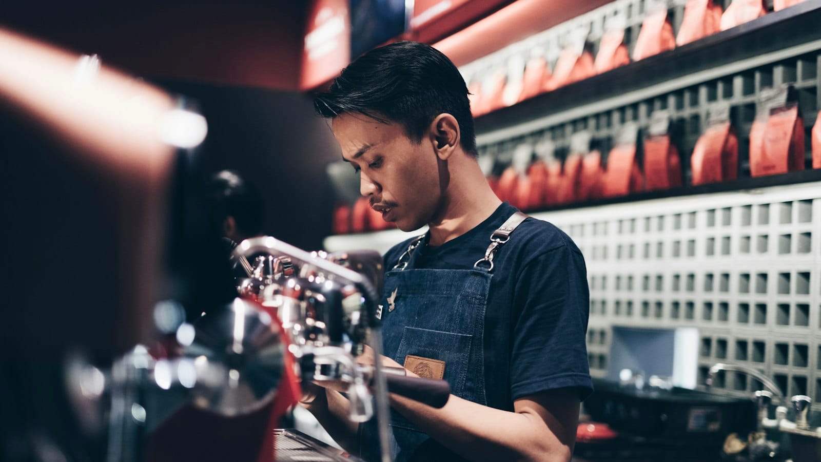 A barista making coffee at an espresso machine