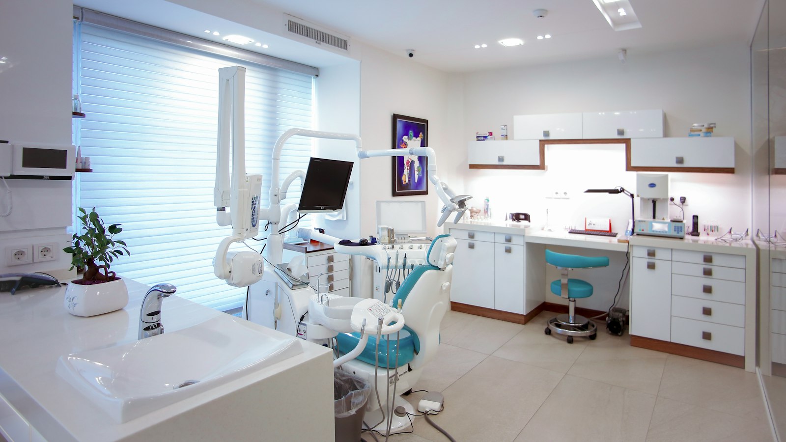 A dental treatment room with a patient chair and equipment