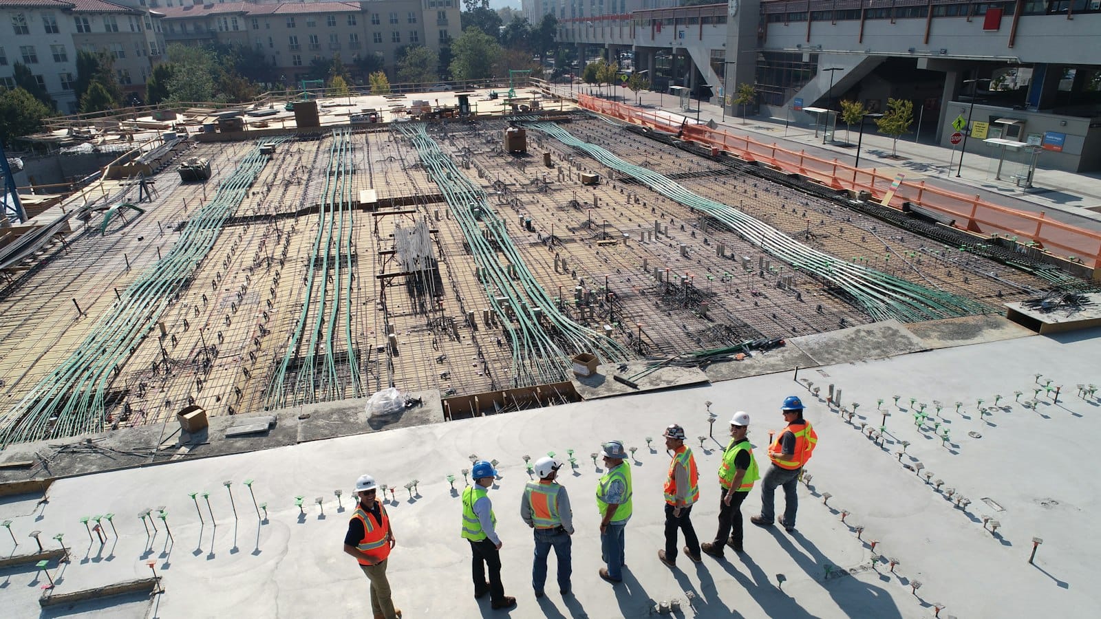 A group of construction workers in hard hats on a building site