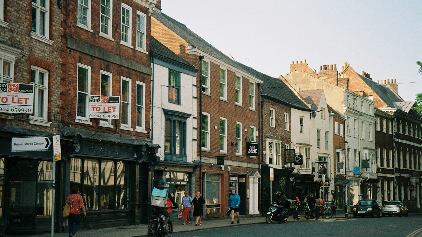 People walking along a busy city street