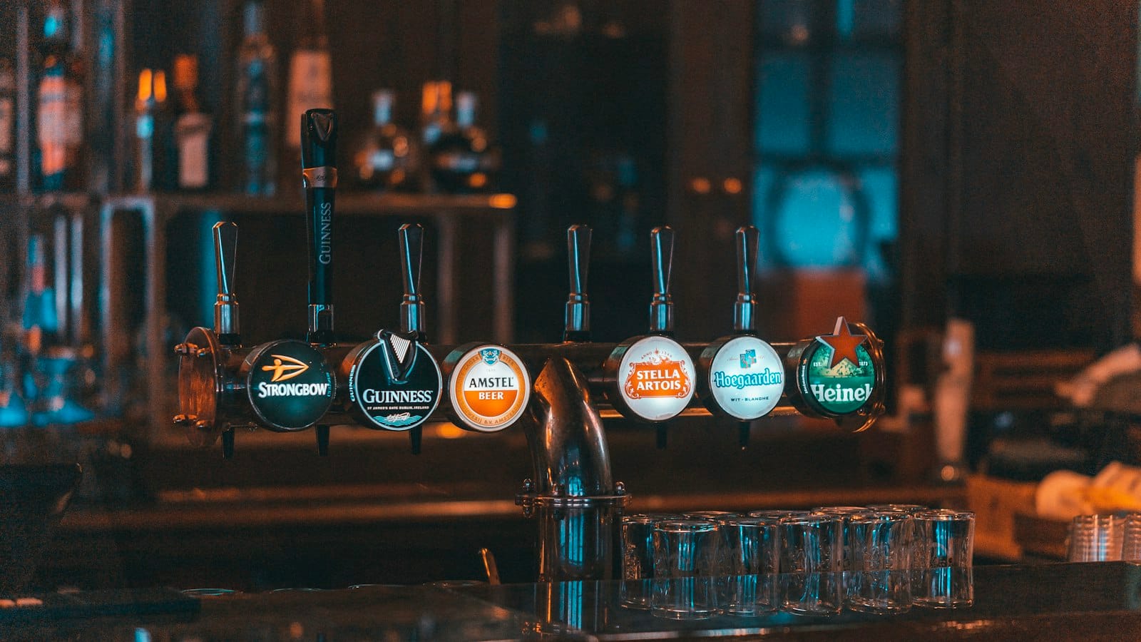 A row of beer taps on a pub bar
