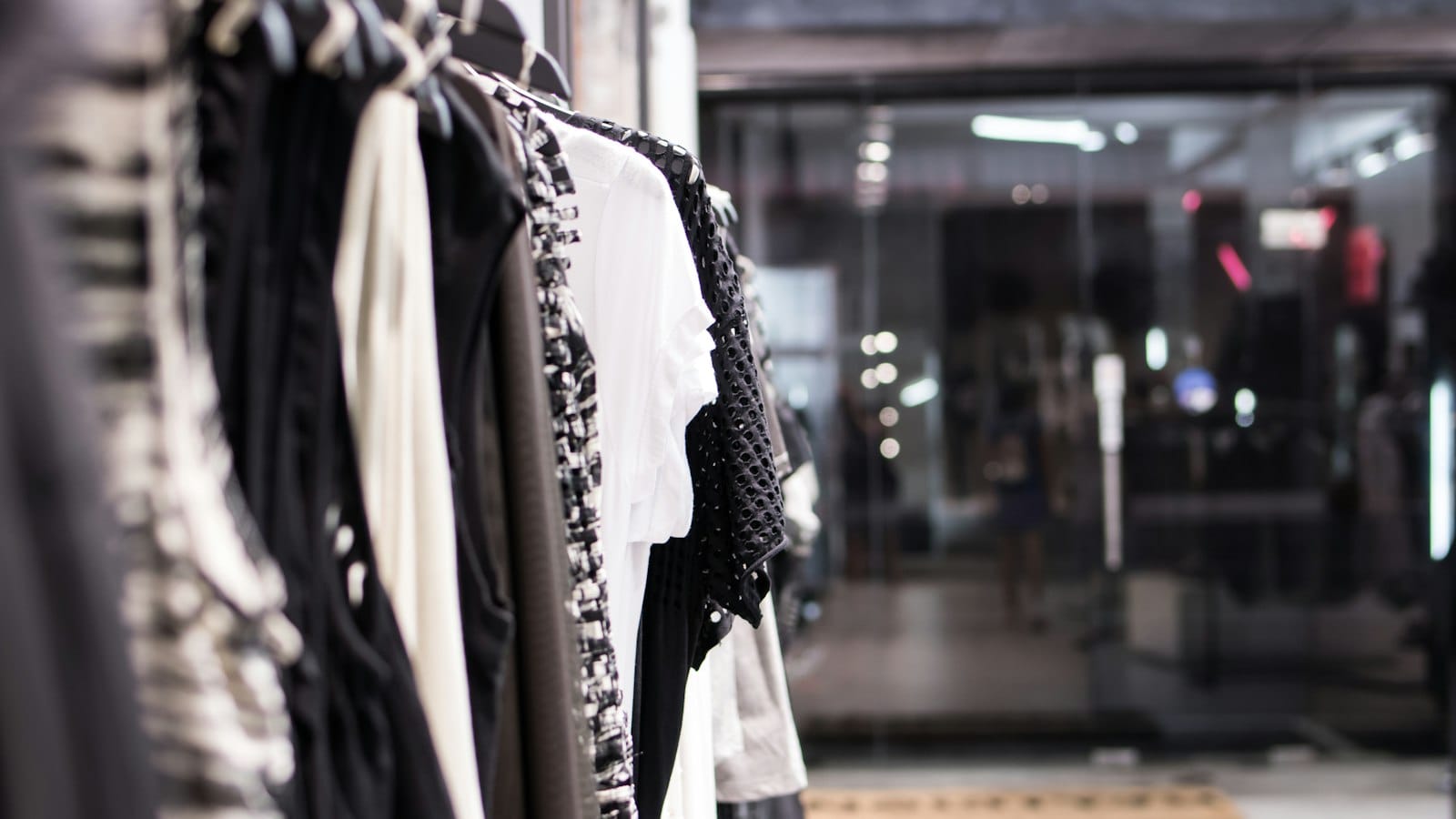 Clothes hanging on rails in a shop
